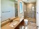 Elegant bathroom with a granite countertop vanity and a glass-enclosed walk-in shower with stylish tile accents at 5169 Sandy Shore Ave, Sarasota, FL 34242