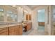 Bright bathroom featuring double vanity, granite countertop, and tiled shower with glass door at 5169 Sandy Shore Ave, Sarasota, FL 34242