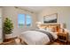 Bright bedroom with modern furnishings, a large window, and light hardwood floors at 5169 Sandy Shore Ave, Sarasota, FL 34242