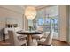 Elegant dining area with a stylish chandelier, seating for four, and seamless access to the outdoor entertainment area at 5169 Sandy Shore Ave, Sarasota, FL 34242