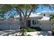 Stunning single-story home featuring a durable metal roof, a brick-paved driveway, and a well-manicured front yard at 5169 Sandy Shore Ave, Sarasota, FL 34242