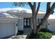 Beautiful home featuring a three car garage, lush landscaping, and a paver driveway at 5169 Sandy Shore Ave, Sarasota, FL 34242