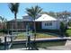 Waterfront home exterior showcasing boat lift, landscaped yard, and screened lanai at 5169 Sandy Shore Ave, Sarasota, FL 34242