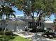 Beautiful single-story home with a three-car garage, lush landscaping, and striking curb appeal at 5169 Sandy Shore Ave, Sarasota, FL 34242