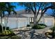 Charming home with a three-car garage, lush landscaping, and a grand oak tree in the front yard at 5169 Sandy Shore Ave, Sarasota, FL 34242