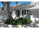 Well-maintained home with a three-car garage, beautiful landscaping, and a grand oak tree in the front yard at 5169 Sandy Shore Ave, Sarasota, FL 34242