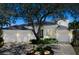 Charming home with a three-car garage, lush landscaping, and a grand oak tree in the front yard at 5169 Sandy Shore Ave, Sarasota, FL 34242
