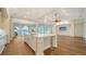 Modern kitchen featuring a large island, hardwood floors, and views of the pool at 5169 Sandy Shore Ave, Sarasota, FL 34242