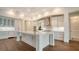 Bright, modern kitchen with custom white cabinetry, large central island, and stainless steel appliances at 5169 Sandy Shore Ave, Sarasota, FL 34242