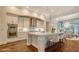 Bright, spacious kitchen featuring a large center island, stainless steel appliances, and modern pendant lighting at 5169 Sandy Shore Ave, Sarasota, FL 34242