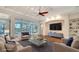 Bright living room with modern furnishings, ceiling fan, and sliding glass doors to the pool area at 5169 Sandy Shore Ave, Sarasota, FL 34242