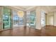 Open living room with hardwood floors and sliding glass doors leading to the pool at 5169 Sandy Shore Ave, Sarasota, FL 34242
