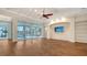 Spacious living room with hardwood floors, coffered ceilings, and pool view at 5169 Sandy Shore Ave, Sarasota, FL 34242