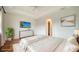 Serene main bedroom with hardwood floors, tray ceiling, dresser, and ample natural light creating a relaxing atmosphere at 5169 Sandy Shore Ave, Sarasota, FL 34242