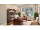 Comfortable office space with a wood desk, built-in bookshelves, and a large window offering plenty of natural light at 5169 Sandy Shore Ave, Sarasota, FL 34242