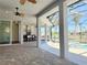 Inviting outdoor living space with kitchen, ceiling fans, pool, canal, and waterfront views, perfect for entertaining at 5169 Sandy Shore Ave, Sarasota, FL 34242