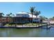 Waterfront home with a private dock, screened lanai, lush landscaping, and views of the canal at 5169 Sandy Shore Ave, Sarasota, FL 34242