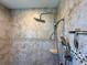 Close-up of a modern shower with mosaic tile accents, a rainfall showerhead, and a handheld shower attachment at 5169 Sandy Shore Ave, Sarasota, FL 34242