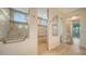 Luxurious walk-in shower with custom tile work, a built-in bench, a rain shower head, and a clear glass enclosure at 5169 Sandy Shore Ave, Sarasota, FL 34242