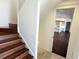 Elegant staircase with wooden steps leading to a bright, open floor plan and views of the modern kitchen at 5169 Sandy Shore Ave, Sarasota, FL 34242