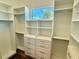 Well-organized walk-in closet with built-in shelving, drawers, and ample storage space with natural light at 5169 Sandy Shore Ave, Sarasota, FL 34242