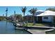 Stunning waterfront residence with a private dock, lush landscaping, and beautiful views of the canal at 5169 Sandy Shore Ave, Sarasota, FL 34242