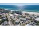 Overhead view of a beachside community with private residences, a community pool and a tennis court at 5400 Gulf Dr # 25, Holmes Beach, FL 34217