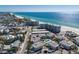 Wide aerial shot of beachside condos, residential homes and white sand beaches on a sunny day at 5400 Gulf Dr # 25, Holmes Beach, FL 34217