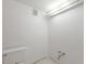 Bright bathroom features a standard toilet and basic plumbing fixtures under a fluorescent light at 5400 Gulf Dr # 25, Holmes Beach, FL 34217
