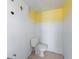 Simple half bathroom with a new toilet and freshly painted yellow trim at 5400 Gulf Dr # 25, Holmes Beach, FL 34217