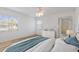 Comfortable bedroom with a large window, wood floors, a ceiling fan, and a dresser at 5400 Gulf Dr # 25, Holmes Beach, FL 34217