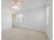 Bright bedroom with a ceiling fan, carpet floors, and a large window with blinds at 5400 Gulf Dr # 25, Holmes Beach, FL 34217