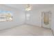 Well-lit bedroom with two windows, a ceiling fan, and a door to the outside at 5400 Gulf Dr # 25, Holmes Beach, FL 34217