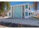 Exterior view of the condo with turquoise block wall and shutters at 5400 Gulf Dr # 25, Holmes Beach, FL 34217