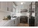 Galley kitchen featuring marble countertops, stainless steel appliances, and white cabinets at 5400 Gulf Dr # 25, Holmes Beach, FL 34217