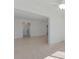 Living room leading to kitchen and other rooms, featuring neutral tile flooring and ceiling fan at 5400 Gulf Dr # 25, Holmes Beach, FL 34217
