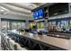 Stylish bar area with a large flat-screen TV, ample seating, and an extensive selection of liquor at 5527 Palmer Cir # 105, Bradenton, FL 34211