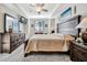 This bedroom offers a large wooden bed, ceiling fan, and beach-themed decorations at 5527 Palmer Cir # 105, Bradenton, FL 34211