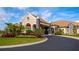 Inviting clubhouse entrance boasts immaculate landscaping and a covered portico at 5527 Palmer Cir # 105, Bradenton, FL 34211