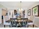 Dining area with wooden table, chairs, and decor, adjacent to the kitchen at 5527 Palmer Cir # 105, Bradenton, FL 34211