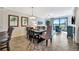 Bright dining area with seating for six flows into a living room with a view of the outdoors at 5527 Palmer Cir # 105, Bradenton, FL 34211