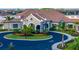 Elegant clubhouse entrance with manicured landscaping offers a welcoming community space at 5527 Palmer Cir # 105, Bradenton, FL 34211