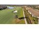 Aerial view of the golf course, with lush greens and a serene pond at 5527 Palmer Cir # 105, Bradenton, FL 34211
