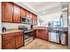 Modern kitchen with stainless steel appliances and dark wood cabinetry at 5527 Palmer Cir # 105, Bradenton, FL 34211