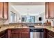Kitchen with granite countertops and stainless steel appliances overlooking the living area at 5527 Palmer Cir # 105, Bradenton, FL 34211