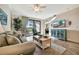 Cozy living room features a comfortable sofa, stylish coffee table, and a serene view of the outdoor landscape at 5527 Palmer Cir # 105, Bradenton, FL 34211