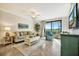 Relaxing living room with a plush sofa, recliner, and sliding glass doors offering views of a golf course at 5527 Palmer Cir # 105, Bradenton, FL 34211