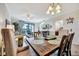 Open living area with dining table, comfortable seating, and sliding glass doors leading to an outdoor view at 5527 Palmer Cir # 105, Bradenton, FL 34211