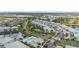 Aerial view of the residential community, showcasing the pool, pond, and mature trees at 5743 Sabal Trace Dr # 101B57, North Port, FL 34287