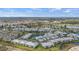 This aerial shows a well-maintained condo community surrounded by lush landscaping and serene water features at 5743 Sabal Trace Dr # 101B57, North Port, FL 34287